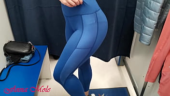In the dressing room, a student tries on various pants for sports. Anna Mole